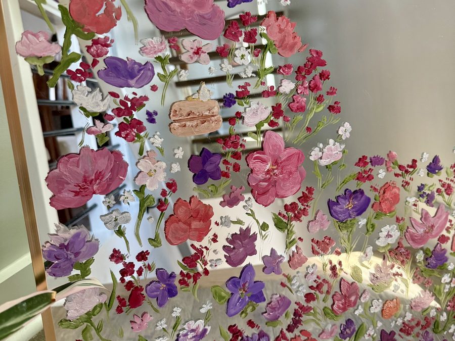 Close detail of the hand-painted roses, tulips and sweet peas on the mirror glass