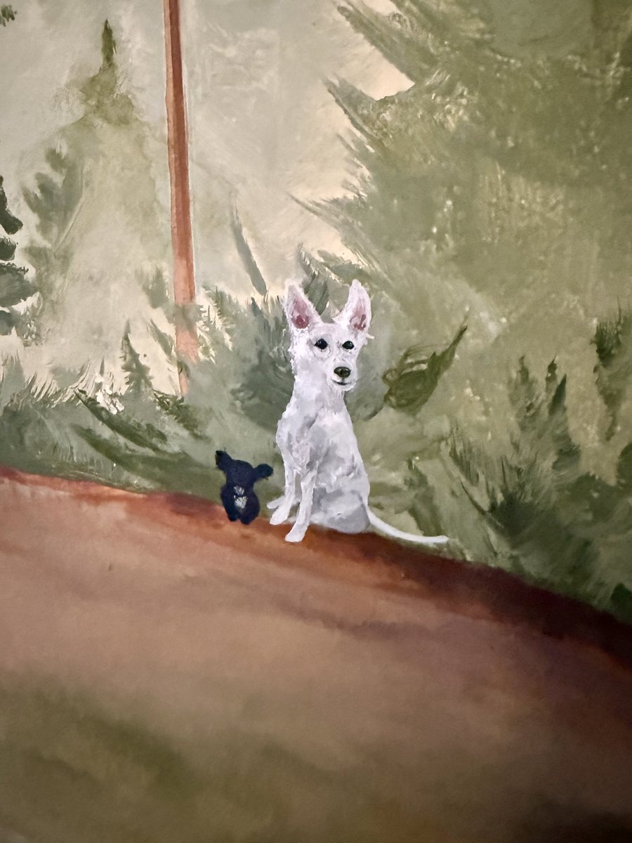 Close detail of a white dog painted sitting on a forest path in the nursery mural, with a small dark dog behind it